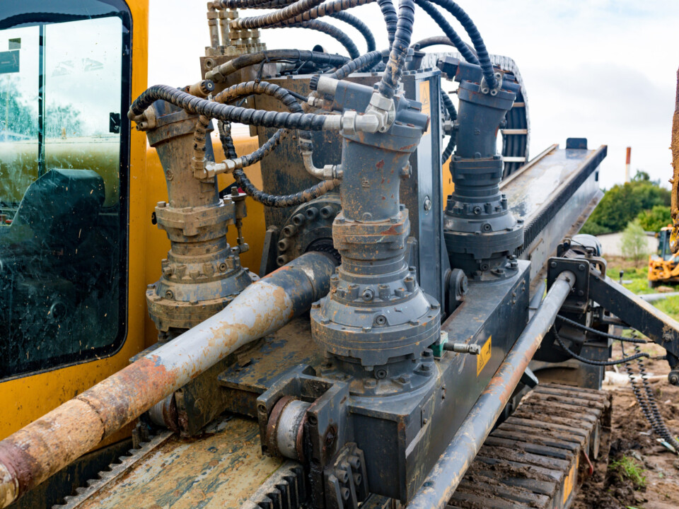Horizontal directional drilling technology closeup. Drilling machine work process. Trenchless laying of communications, pipes and water pipes